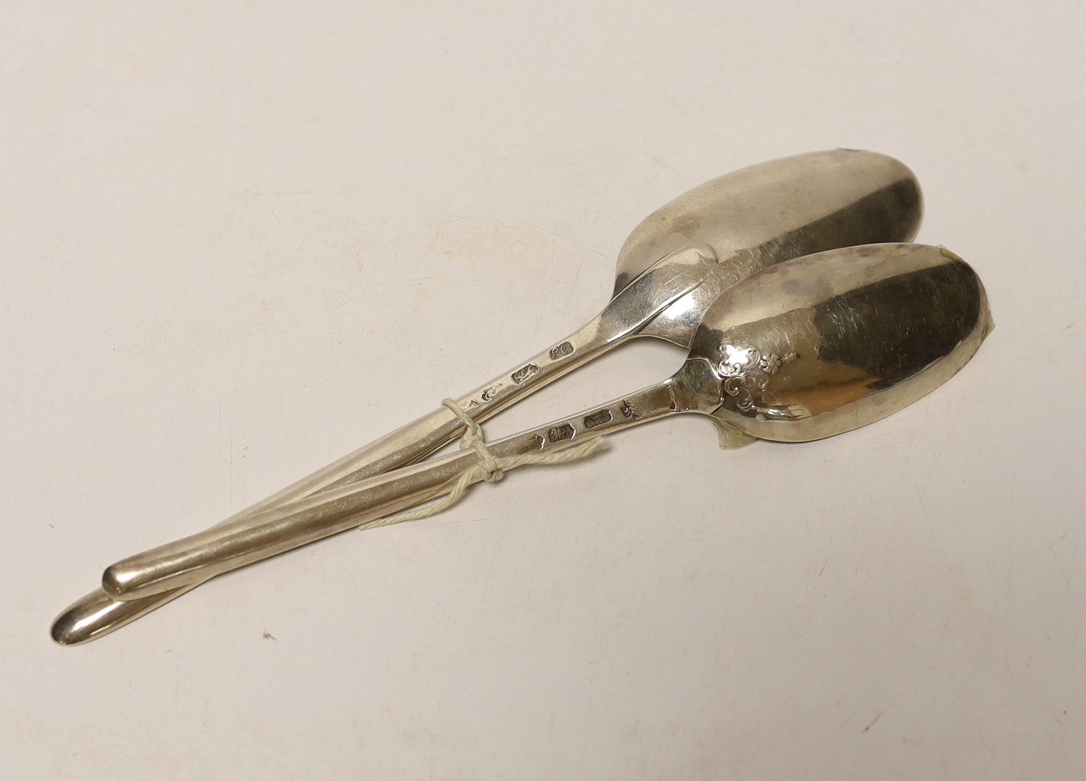 Two 18th century silver combination marrow scoop spoons, smallest with lace back bowl, Marmaduke Daintrey, London, 1741, the other later by Ebeneezer Coker, 21.5cm, 99 grams.